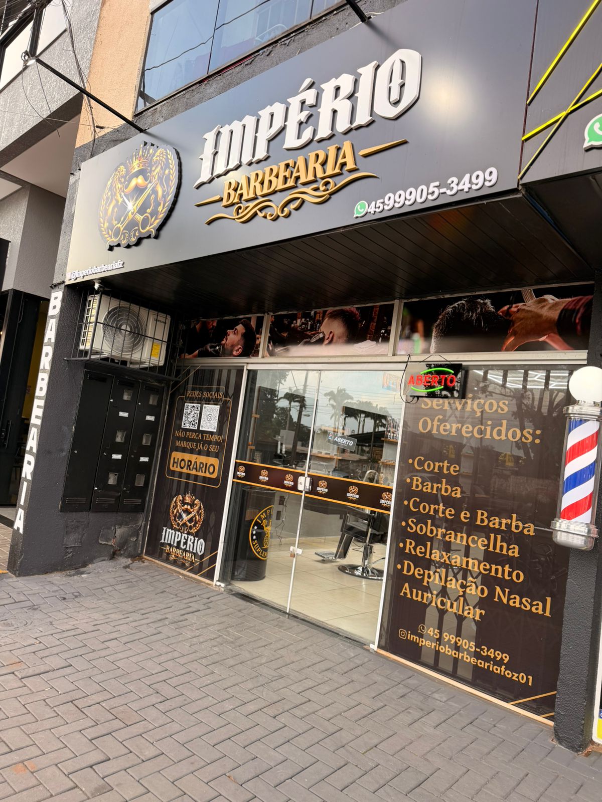 Fachada da Império Barbearia com letreiro iluminado